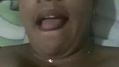 Indian aunty with sexy full lips takes big natural boobs out in bed