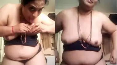 Mature aunty sucking her own boobs